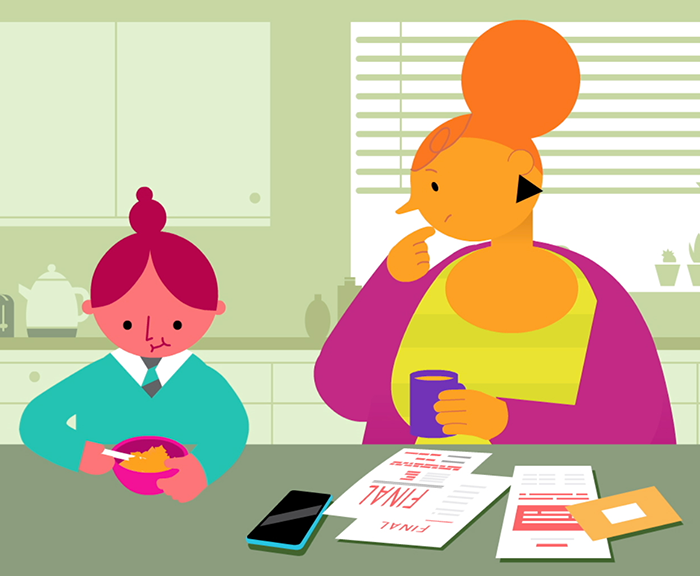 COSD child and parent in kitchen with bills