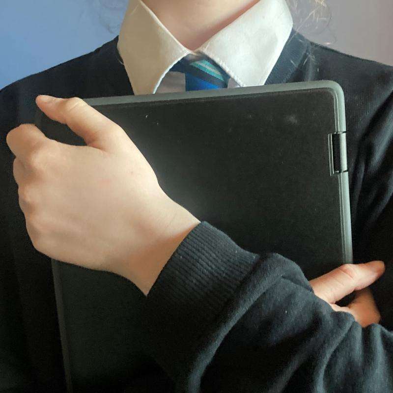 school student holding a laptop