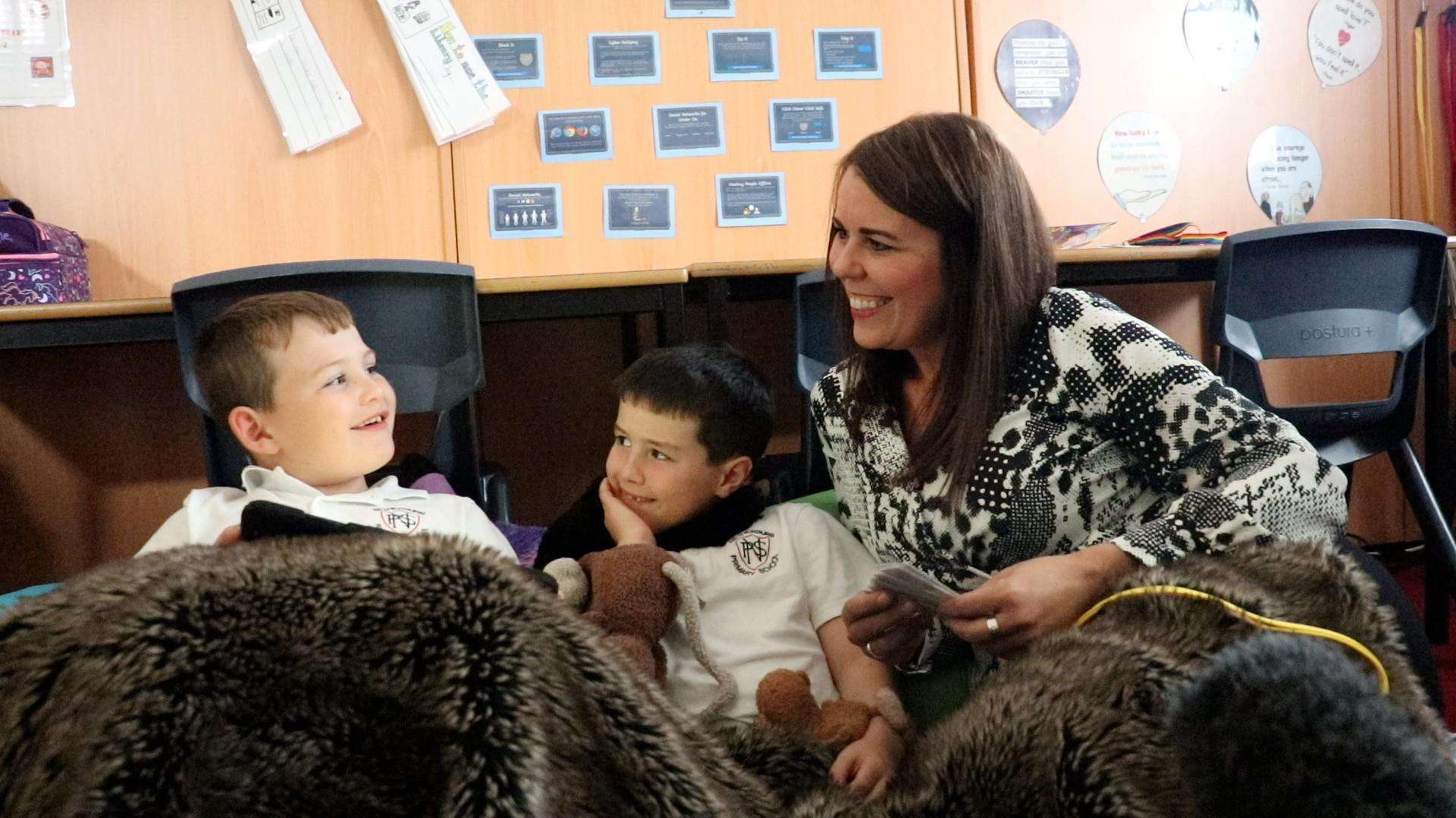 two boys and their teacher at the storytime club at Netherburn Primary School